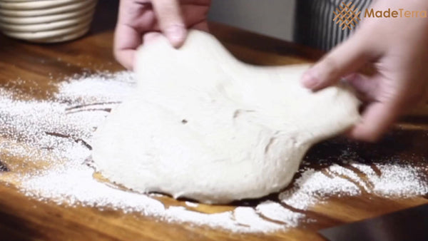 spread high hydration dough on the flour shaping surface